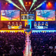 A picture of a crowd watching esport players compete in a Halo event on a large stage.